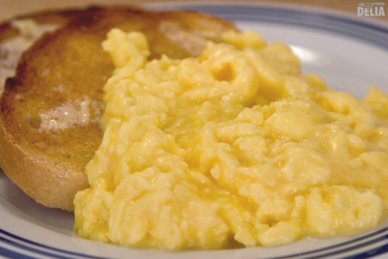 Scrambled eggs with two slices of toast on a plate