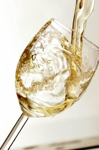 White wine flowing into a glass