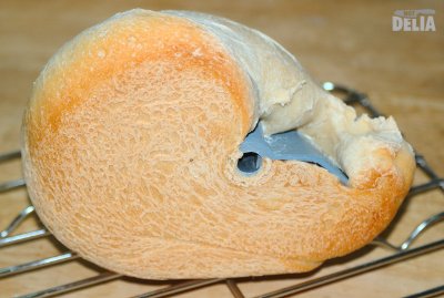 Mr Not Delia's white bread from below. Lovely, but you could break your teeth on it. A loaf of bread-making machine bread from below, showing the dough-hook still embedded