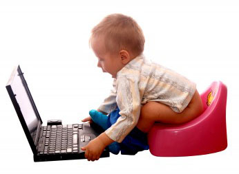 A toddler sitting on a potty with a laptop