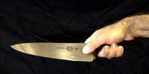 How to hold a chefs knife - the classic professional grip How to hold a chef's knife: the classic professional grip - thumb on one side of the blade, index finger on the other, and the other three fingers wrapped round the handle