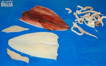 Two squid - tentacles all chopped up, one hood trimmed and scored, the other hood intact