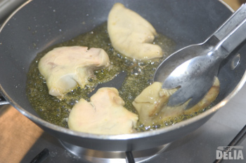 Medallions of duck foie gras being turned in the pan