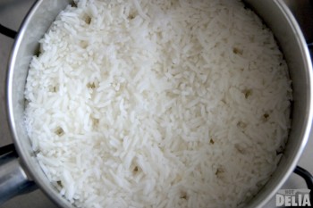 Steaming rice, with craters caused by steam