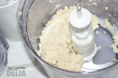 Pastry mix nearly completely mixed - large lumps of mixture in a food processor jug