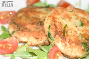 Salmon fishcakes with spinach on a bed of rocket leaves with cherry tomatoes