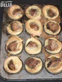Mini toads-in-the-hole - sausage baked in batter - in a baking-tin