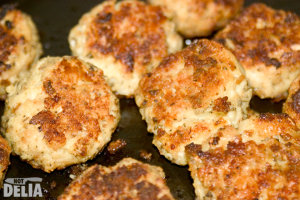 Cooked sage and onion stuffing balls on a baking tray