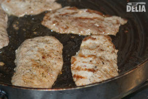 Pork escalopes frying in a pan