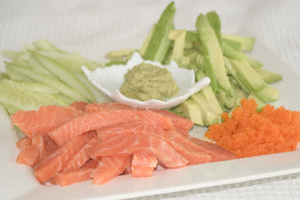 Batons of salmon, avocado and cucumber with wasabi and fish roe presented on a plate