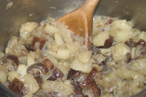 Apples, onions, sultanas and dates cooked in a saucepan