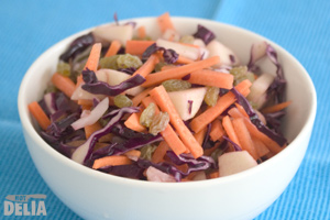 Chunky salad with red cabbage, carrot, apple and sultanas in a bowl