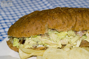 Chicken, bacon and avocado sandwich on a wholemeal sub with crisps on the side