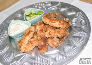 Fish goujons in breadcrumbs with lime wedges and tartar sauce