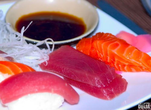 Sashimi and sushi with a bowl of soy sauce