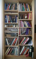 Bookcase with several dozen cookbooks