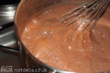 Hot chocolate being whisked in the pan