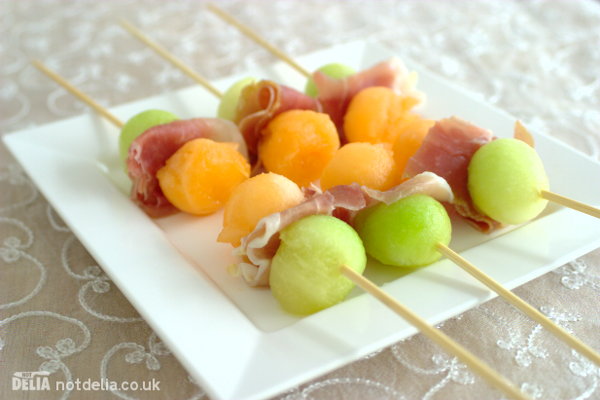 Parma ham with melon balls on skewers