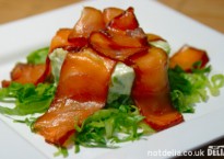 Marinated salmon served on a mousse and salad bed